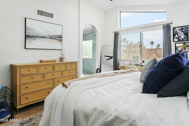 bedroom featuring dark hardwood / wood-style floors and lofted ceiling