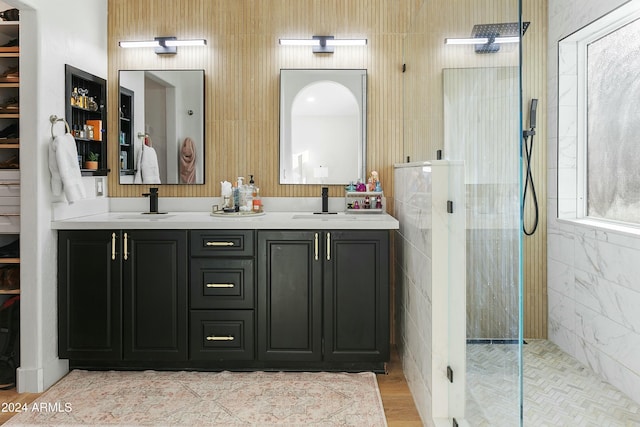 bathroom featuring tiled shower and vanity