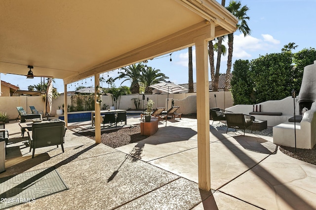 view of patio / terrace featuring a fenced in pool and an outdoor living space