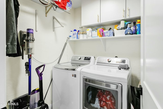 laundry area featuring cabinets and washer and clothes dryer