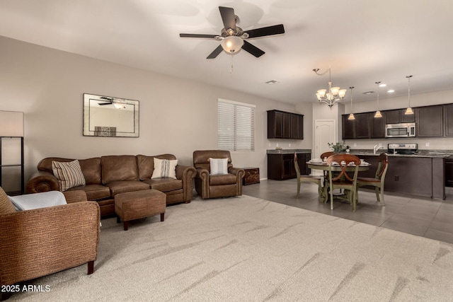 12109 W Tether Trl, Peoria, AZ 85383 - living room with ceiling fan, a chandelier, light carpet, and recessed lighting