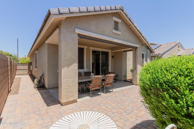 12109 W Tether Trl, Peoria, AZ 85383 - rear view of house with stucco siding, a patio, and outdoor dining area