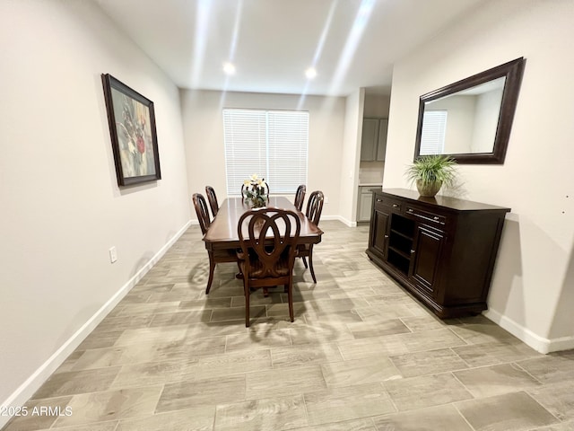 dining room featuring baseboards and recessed lighting