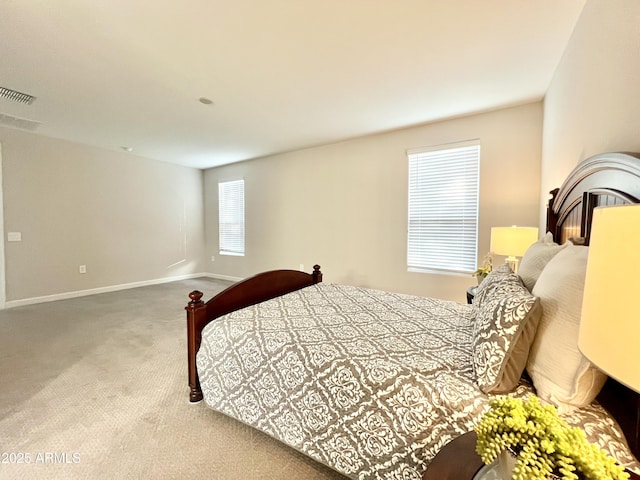 carpeted bedroom with visible vents and baseboards