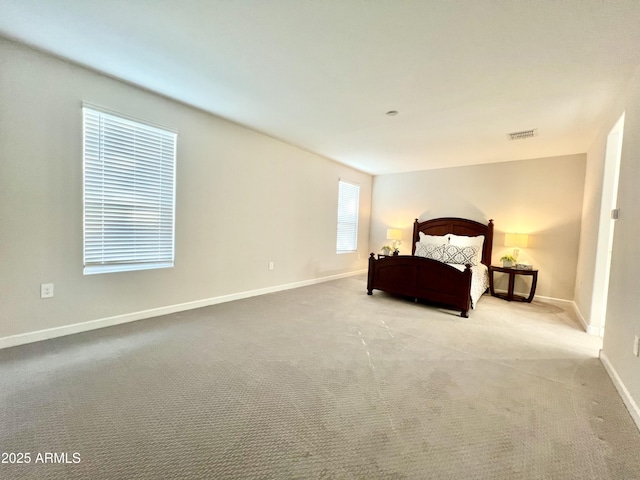 bedroom featuring carpet flooring, visible vents, and baseboards