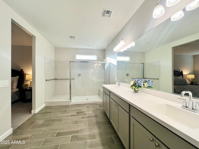 bathroom featuring walk in shower, ensuite bathroom, visible vents, and a sink
