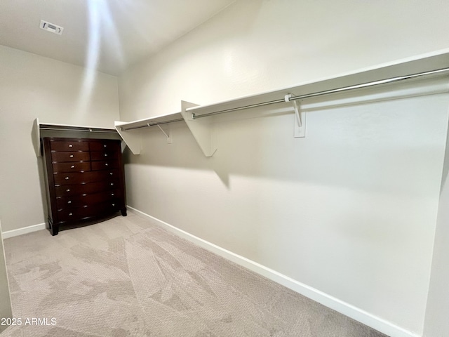 spacious closet with light colored carpet and visible vents