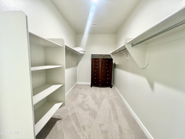 walk in closet featuring carpet flooring