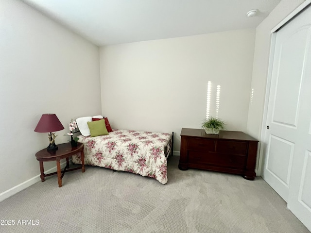 bedroom featuring carpet and baseboards