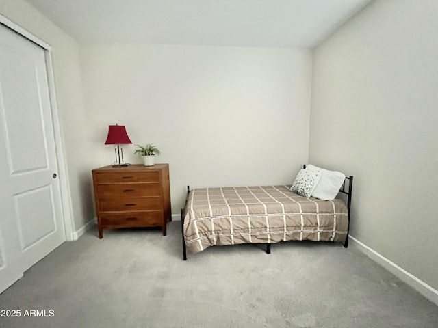 bedroom with baseboards, carpet flooring, and a closet