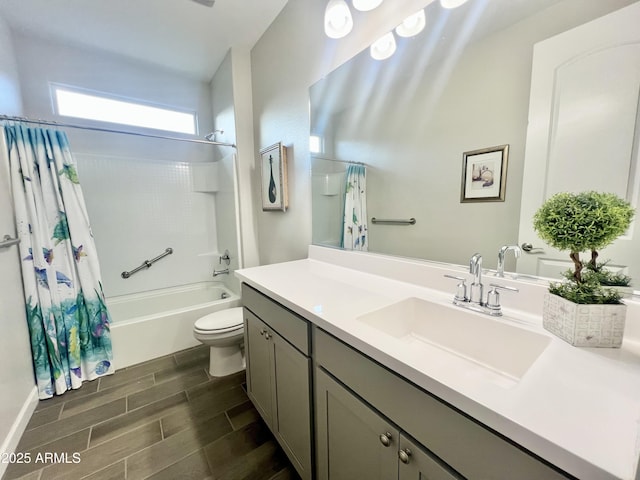 full bathroom with toilet, vanity, wood finish floors, and shower / bath combo