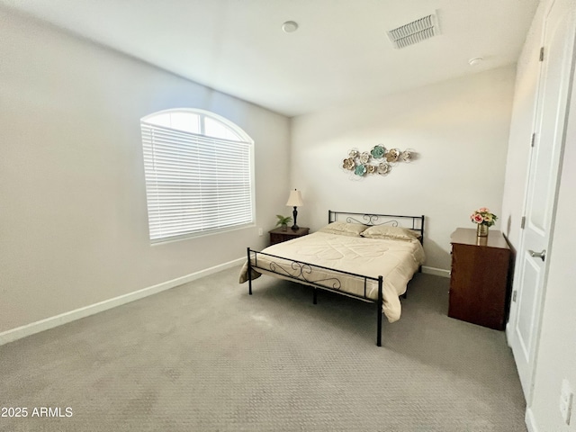 carpeted bedroom featuring baseboards and visible vents