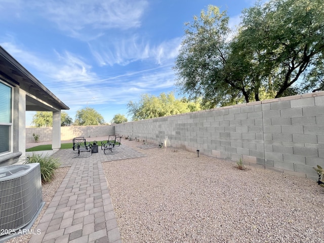 view of yard featuring cooling unit, a patio area, and a fenced backyard