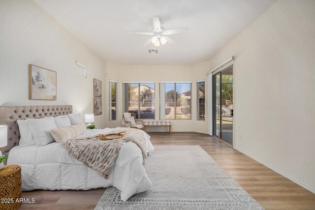 bedroom with ceiling fan and light hardwood / wood-style flooring