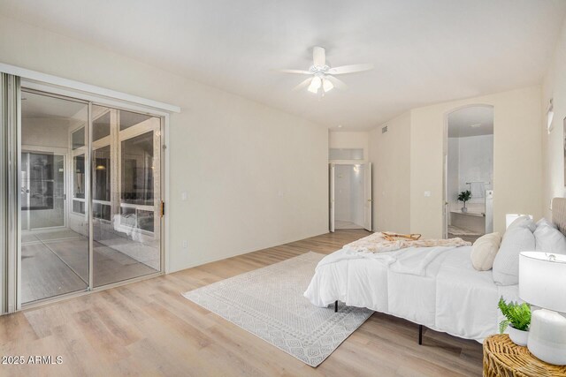 bathroom featuring hardwood / wood-style floors, walk in shower, and vanity