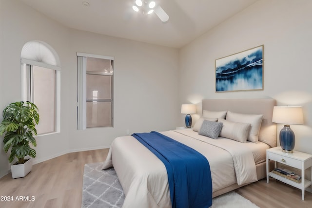 bedroom with light hardwood / wood-style floors and ceiling fan