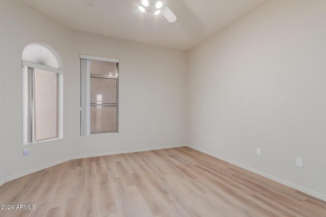 unfurnished bedroom featuring ceiling fan, light hardwood / wood-style flooring, and a closet