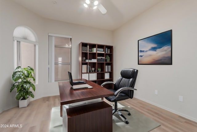 office with light wood-style floors, baseboards, and a ceiling fan