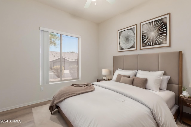 bedroom with light hardwood / wood-style flooring and ceiling fan