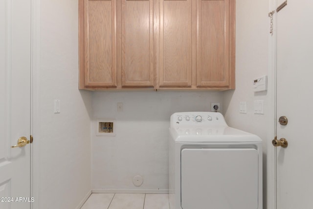 laundry area with washer / dryer, cabinet space, baseboards, and light tile patterned floors