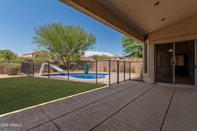 view of swimming pool with a fenced in pool, fence private yard, a lawn, and a patio