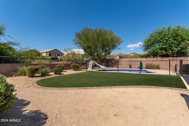 view of yard with fence and a fenced in pool