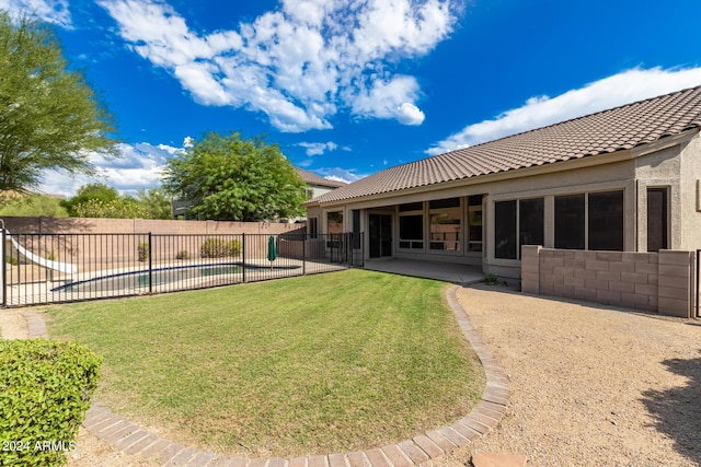 view of yard featuring a patio area, fence, and a fenced in pool