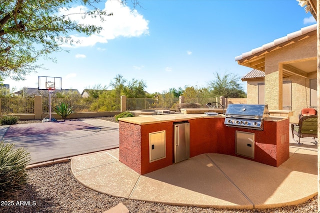 view of patio / terrace featuring exterior kitchen and grilling area