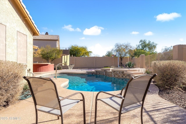 view of pool with an in ground hot tub and a patio