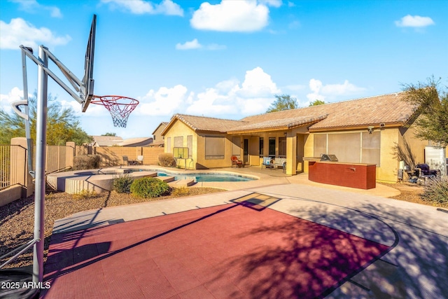 view of basketball court with a fenced in pool