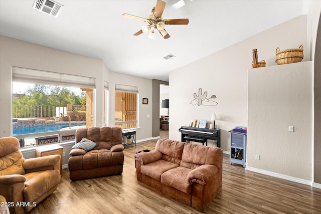 living room featuring ceiling fan and wood-type flooring