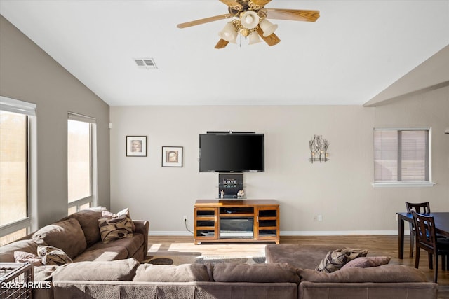 living room featuring lofted ceiling, wood-type flooring, ceiling fan, and a wealth of natural light