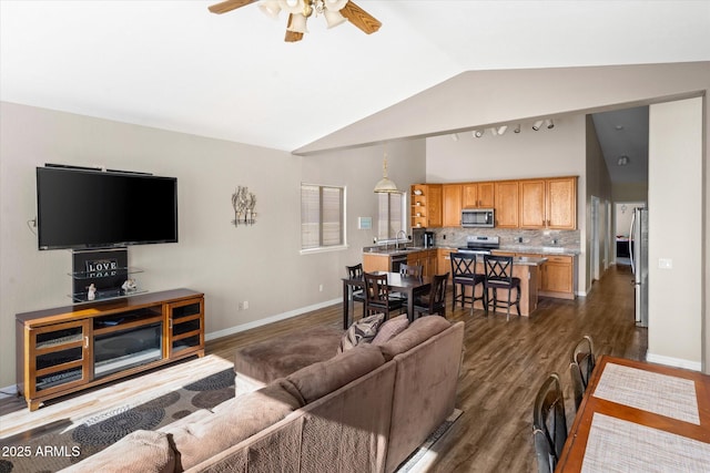 living room featuring lofted ceiling, sink, ceiling fan, and dark hardwood / wood-style floors