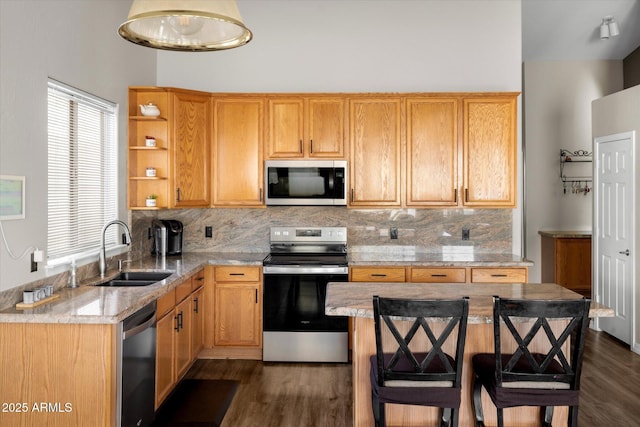 kitchen with stainless steel appliances, a center island, backsplash, and sink