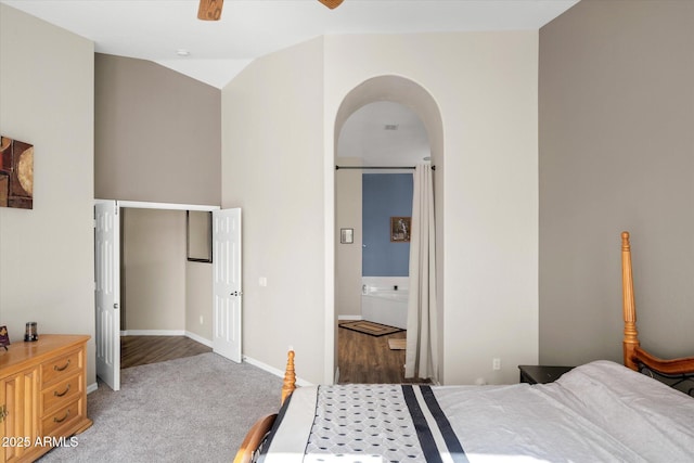 carpeted bedroom featuring ensuite bath and ceiling fan