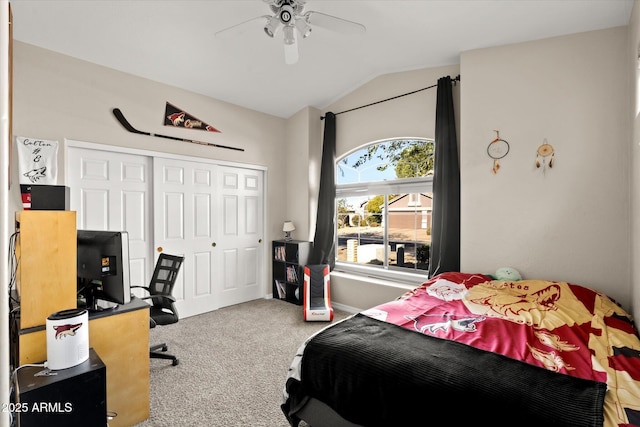 bedroom with vaulted ceiling, ceiling fan, a closet, and carpet flooring