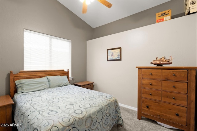 bedroom featuring vaulted ceiling, light colored carpet, and ceiling fan