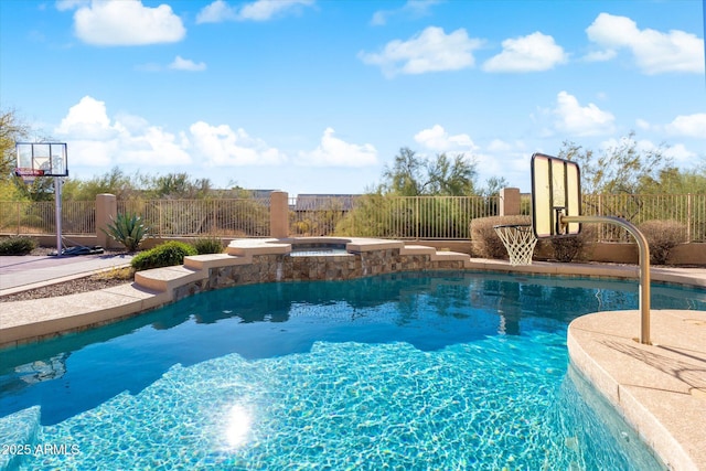 view of pool featuring an in ground hot tub