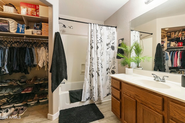 bathroom with vanity, hardwood / wood-style floors, and shower / bath combo