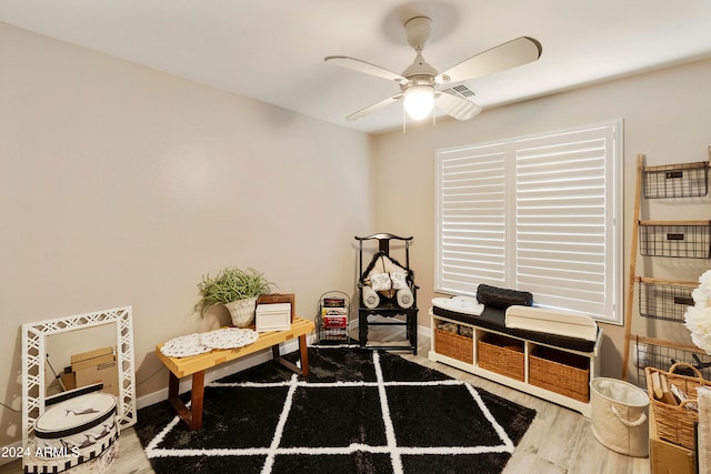 living area featuring ceiling fan and wood-type flooring