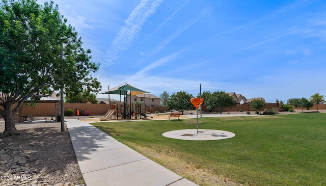 view of community featuring a playground and a lawn