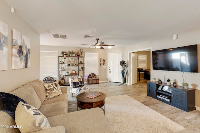 living room with ceiling fan and light wood-type flooring