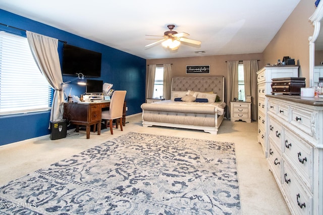 carpeted bedroom with multiple windows and ceiling fan