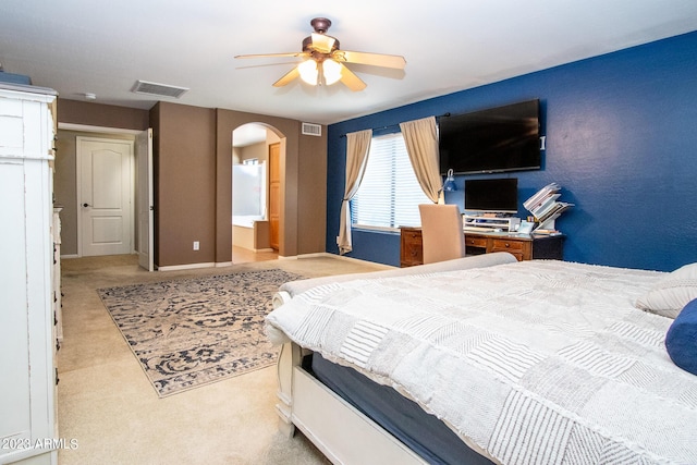 carpeted bedroom featuring connected bathroom and ceiling fan