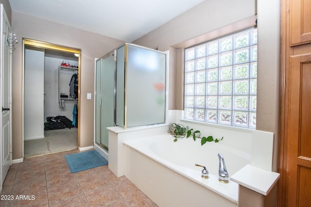 bathroom with independent shower and bath, tile patterned flooring, and a wealth of natural light