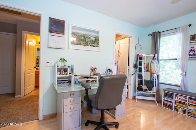 office with light wood-type flooring