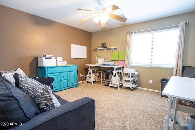 carpeted office featuring ceiling fan