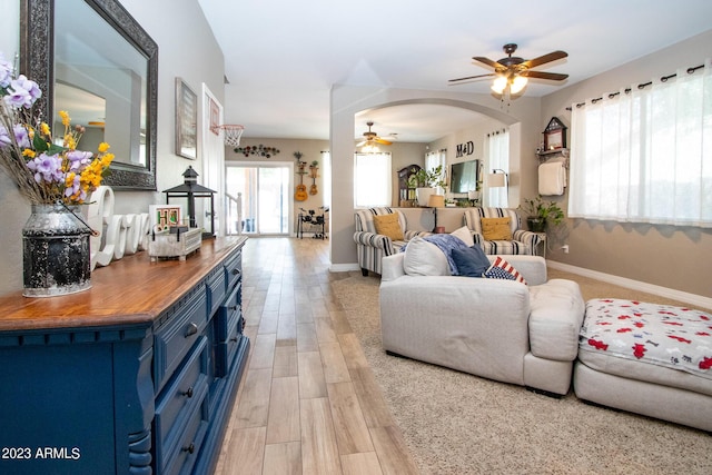 living room with ceiling fan and light hardwood / wood-style floors