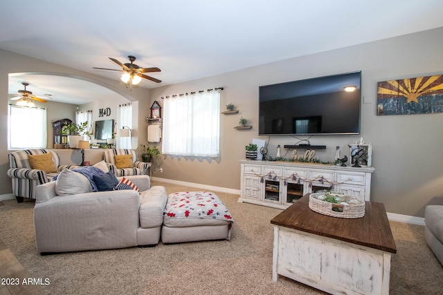 living room with ceiling fan and carpet