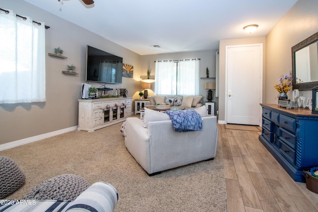 living room with ceiling fan and light hardwood / wood-style floors